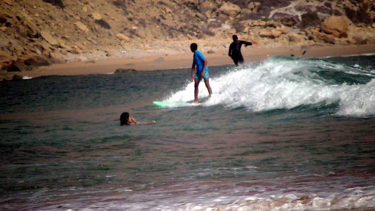A surfer riding a wave at Imsouane